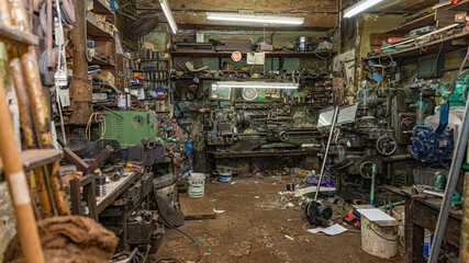 Canvas Print - Shop of a machines engines repair master has the tools, machines and equipment, motor on ground