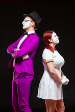 Portrait Of Two Mime Artists, Isolated On Black Background. Young Woman And Man Turn Away From Each Other. Symbol Of Resentment, Quarrel, Dont Speak