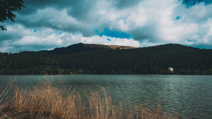 Wall Mural - Beautiful view of a lake and mountains under the cloudy sky