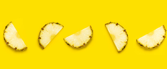 Wall Mural - Pineapple slice against on a yellow background. Top view, flat lay. Banner