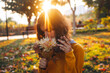 © Anna - Curly young girl in yellow sweater on grass with autumn bouquet of dry leaves and flowers