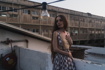 Poster - Pretty Caucasian woman with long hair posing on the balcony of a building