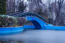 Wooden Blue Bridge And A Frozen Lake On A Winter Evening, Romania, Europe