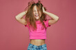 Energetic naughty hooligan little child girl ruffle long blond hair, having fun. Child's hairs care. Positive emotions
