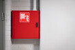 Fire cabinet with extinguisher and hydrant hose on white wall background. Firefighters and rescue safety equipment and emergency gear in red box with emblem or sign sticker in modern office building