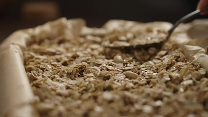 Wall Mural - Slow motion making granola in baking tray, tamp