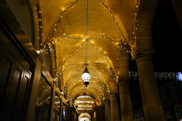 Christmas lights in a arch way of building  