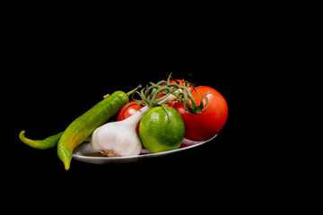 Sticker - Close-up shot of vegetables in a plate on black background