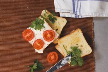 Wall Mural - Closeup of sandwiches with toast bread, tomatoes, cheese, and parsley.