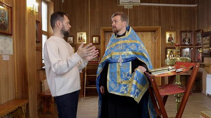 Wall Mural - a man repents of his sins, confesses with a priest in the Orthodox church