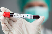 Doctor Medical Worker Holding Test Tube Specimen Holder Containing Omicron Variant Coronavirus Patient Blood Sample