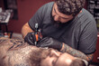 © Mr. Prof - Professional tattooer at work tattoo parlor