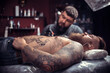 © Mr. Prof - Professional tattooist working on professional tattoo machine device in tattoo parlour