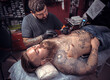 © Mr. Prof - Tattooer making tattoo in salon tattoo parlor