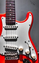 Red Electric Guitar Fretboard And Body On Gray Background