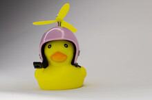 Yellow Rubber Duck On White Background In Pink Helmet With Yellow Propeller