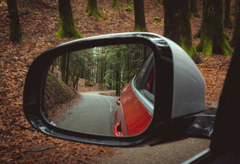 Poster - Shallow focus of an autumn scene from the car mirro