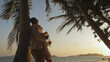 Loving couple near palm tree, kissing, hugging, relax and drinki