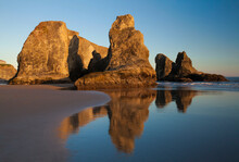 Golden Light On Beautiful, Natural Sea Stacks With Stunning, Smooth Reflections On The Beach In Bandon, Oregon
