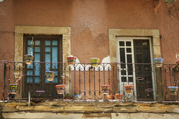 Sticker - Old apartment building with a grungy dirty weathered damaged balcony in Guanajuato