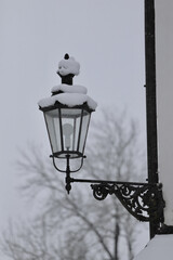 Wall Mural - Vertical shot of a snow-covered street lamp