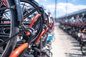 Poster - Closeup of a bicycle wheels with other bicycles in the blurred background