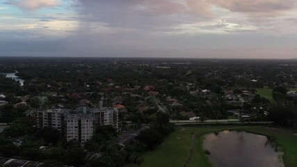 Wall Mural - An aerial drone footage above Fort Lauderdale city in sunset under a cloudy sky