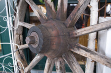 Close-shot Of A Huge Wooden Spoke Wheel As A Decoration