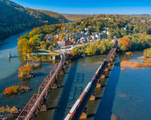 Beautiful Aerial View Of Bridges On Water, Trees, Houses And A Blue Sky In Harpers Ferry Town, USA