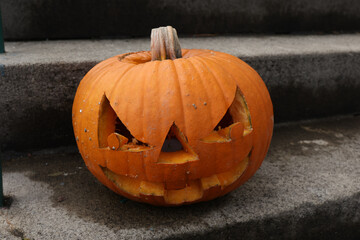 Wall Mural - Halloween pumpkin on the steps at the entrance to the house