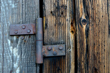 Closeup Shot Of An Old Rusty Hinge On A Wooden Door