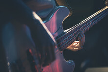 Close-up Of A Man Playing The Bass Guitar.