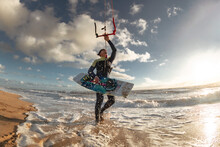 Kite Surfer Stands In Water With Wakeboard