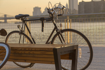 Wall Mural - Closeup shot of a bicycle leaned on a wooden bench