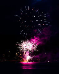 Sticker - Vertical shot of big colorful fireworks in the night sky