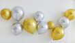 © hippomyta - Shiny golden and silver balloons arrangement on the wall