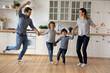© fizkes - Happy family with two kids dancing in modern kitchen together, celebrating relocation into new apartment, mortgage or rent, smiling Caucasian mother and father with children having fun at home