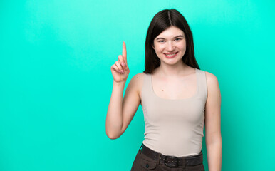 Young Russian woman isolated on green background pointing up a great idea