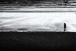 silhouette of a lady on the beach in black and white Cornwall UK 