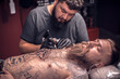 © Mr. Prof - Master of the art of tattooing during a tattoo artist session tattoo studio