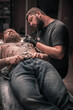 © Mr. Prof - Tattoo artist makes cool tattoo in tattoo parlour