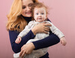 © rubchikova - mother and daughter isolated on pink