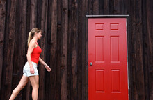  Woman Walks Toward Red Door.
