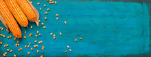 Corncobs And Grain On Rustic Wooden Background, Top View Of Harvested Maize Crops