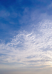 Wall Mural - Beautiful view of sky with clouds at sunrise. Partly cloudy. Colorful sunset. Natural blue sky background texture, beautiful color.