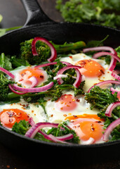 Wall Mural - Green shakshuka with golden yolk eggs, kale, spinach and tender broccoli served with pickled onions and chilli flakes