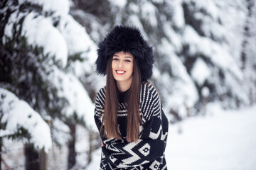 Portrait of happy woman in sweater at winter 