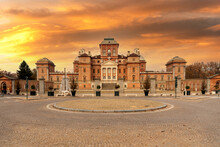 Racconigi, Cuneo, Piedmont, Italy - The Royal Castle Of Racconigi (14th-18th Century) With Sky With Sunset Colors. Summer Royal Residence Of The Savoy Family. UNESCO Heritage.