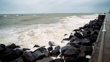Stormy waves crashing against a seas defence shoreline