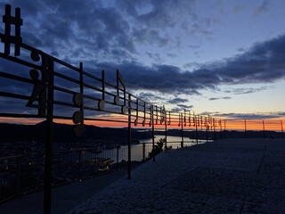 Observation deck with musical notes on metal handrails at sunset